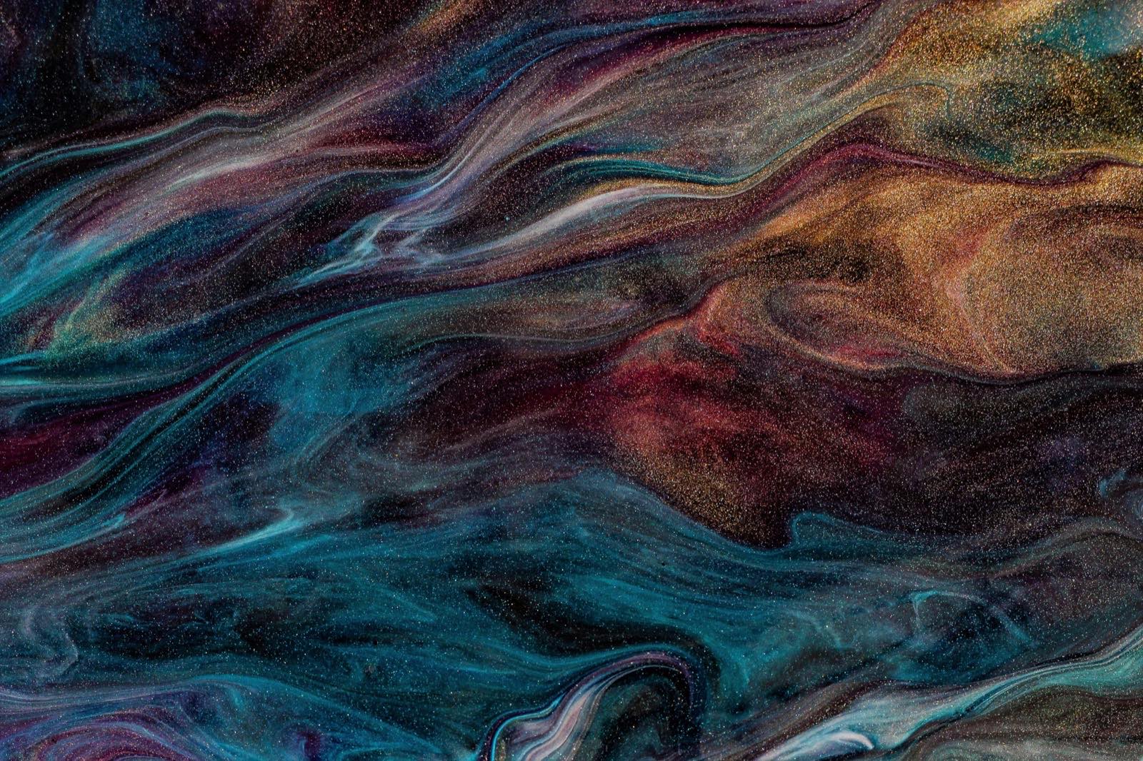 Dark iridescent marbled ink in teal, copper and deep red